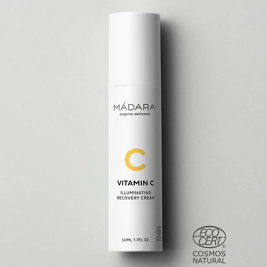 Envase blanco de la crema iluminadora con Vitamina C de MÁDARA (Vitamin C Illuminating Recovery Cream) de 50 ml sobre fondo gris con el sello certificado de COSMOS Natural.