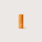 Mini frasco naranja de diez mililitros del Sérum Booster con Vitamina C al 30 por ciento de Novexpert en tamaño de viaje.